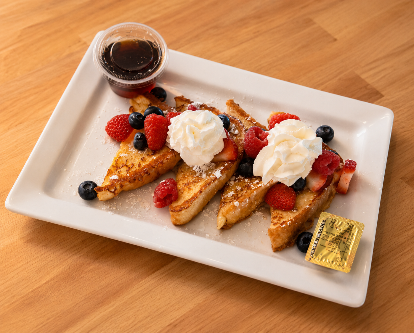 French toast with fresh berries, whipped cream and maple syrup